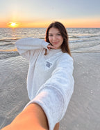 Woman wearing a gray Christian Crewneck Sweatshirt on the beach at sunset
