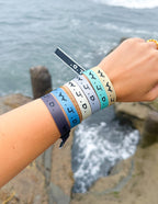 Elevated Faith Christian Jewelry Bracelet in multiple colors worn on wrist near water