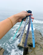 Elevated Faith Christian Jewelry Bracelet collection featuring colorful wristbands by the ocean