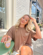 Elevated Faith Christian Apparel T-Shirt in brown with 'Jesus Friend' design, modeled outdoors