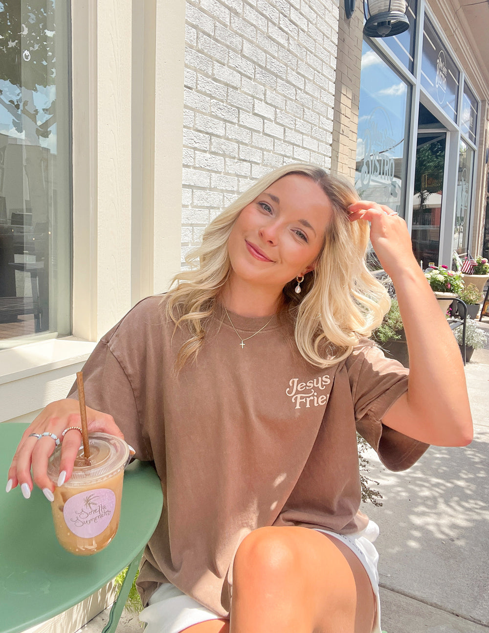 Elevated Faith Christian Apparel T-Shirt in brown with 'Jesus Friend' design, modeled outdoors