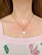 Elevated Faith Christian Jewelry featuring a delicate cross necklace on a model's neck
