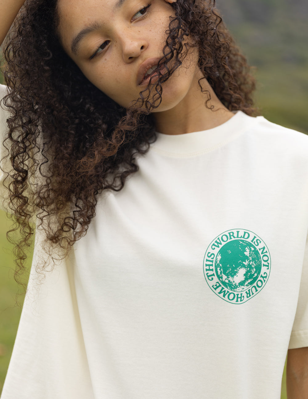 Elevated Faith Christian Apparel T-Shirt with green earth graphic and text 'This World Is Not Home'