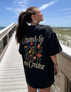 Elevated Faith Christian Apparel T-Shirt with floral design saying Created by the Creator on the back