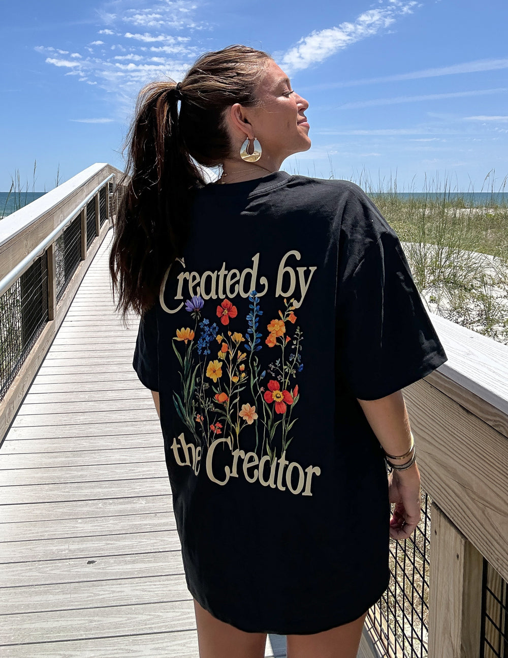 Elevated Faith Christian Apparel T-Shirt with floral design saying Created by the Creator on the back