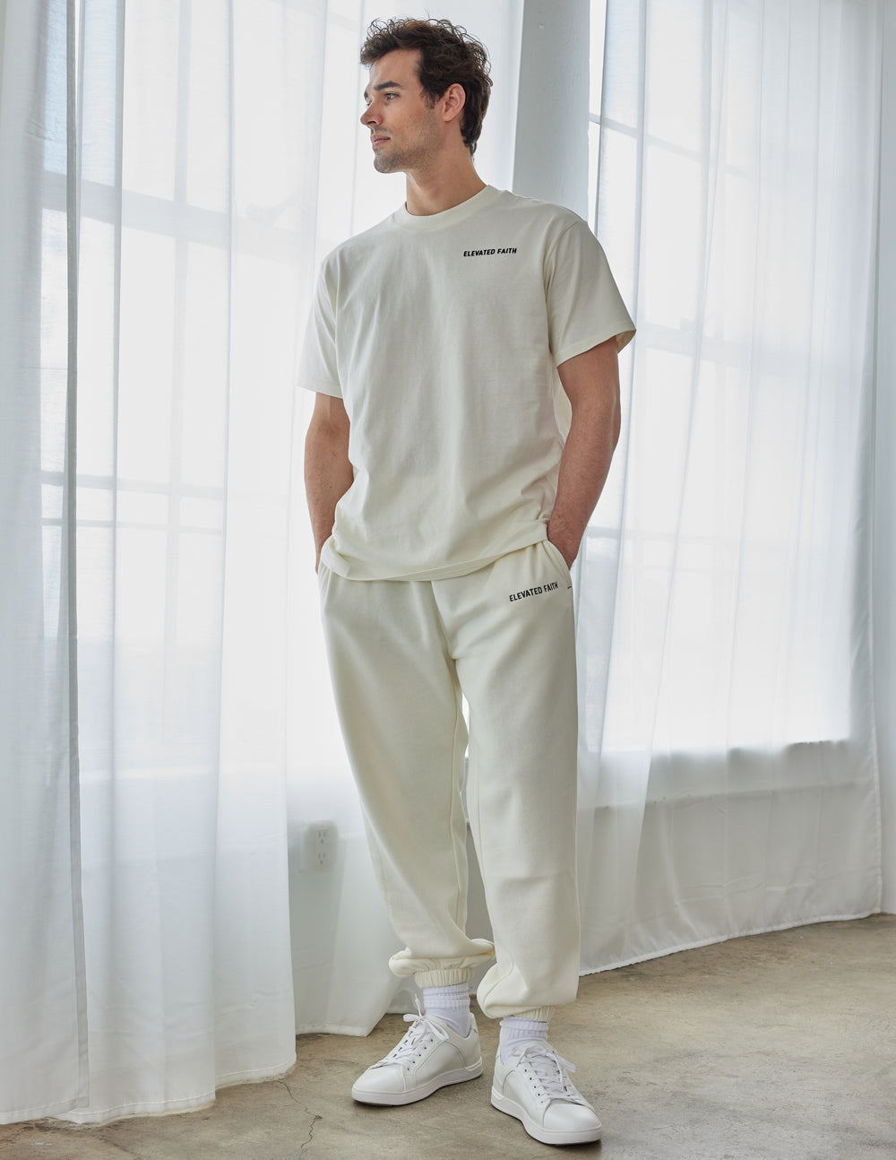 Elevated Faith Christian Apparel T-Shirt in cream color, worn by a model, styled with matching bottoms