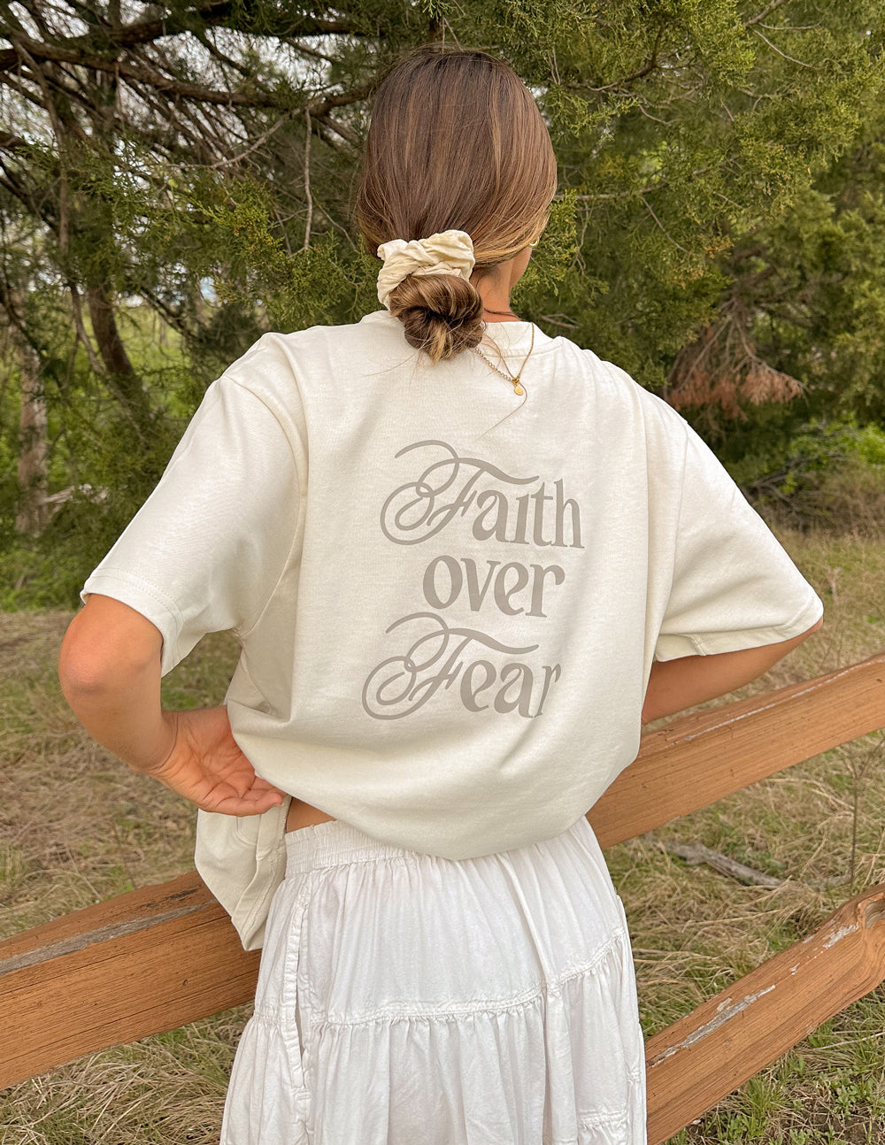 Cream Elevated Faith Christian Apparel T-Shirt featuring 'Faith over Fear' graphic on the back