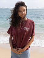 Elevated Faith Christian Apparel T-Shirt in Maroon with 'Forgiven & Free' design, perfect for beach wear.