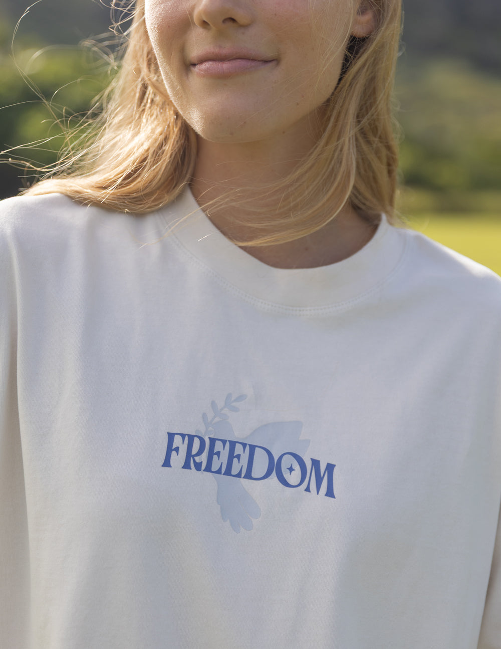 Elevated Faith Christian Apparel T-Shirt featuring a 'Freedom' design with a dove graphic in soft colors