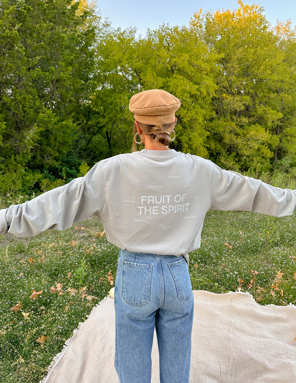 Elevated Faith Christian Apparel T-Shirt with 'Fruit of the Spirit' design in a casual outdoor setting