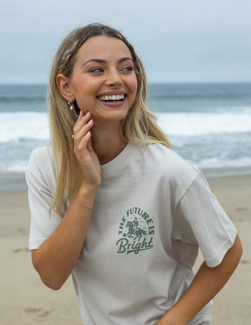 Elevated Faith Christian Apparel T-Shirt with 'The Future is Bright' design on a beach backdrop