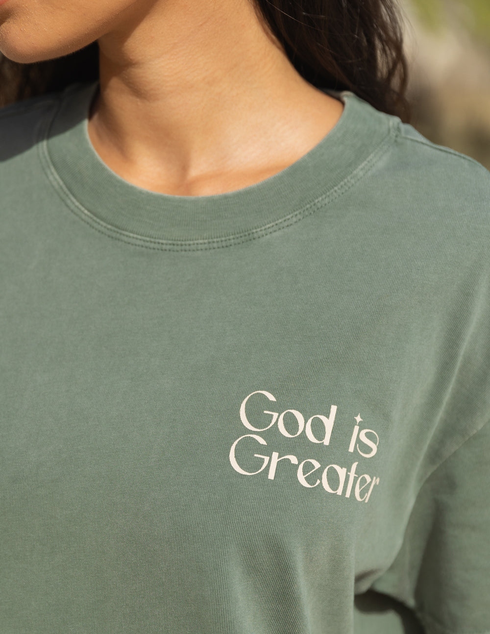 Elevated Faith Christian Apparel T-Shirt in olive green with 'God is Greater' graphic on the front