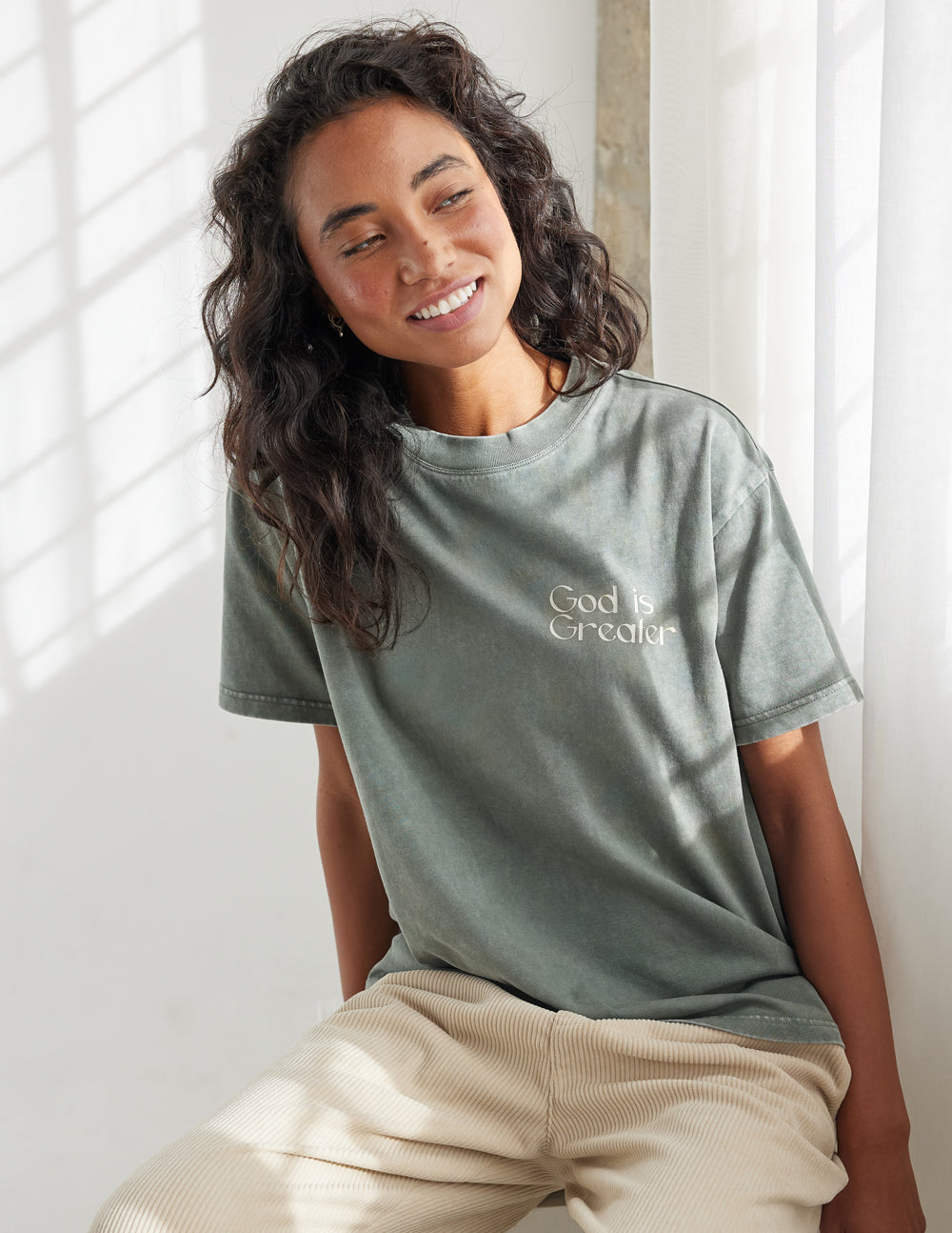 Elevated Faith Christian Apparel T-Shirt in soft green with 'God is Greater' text design