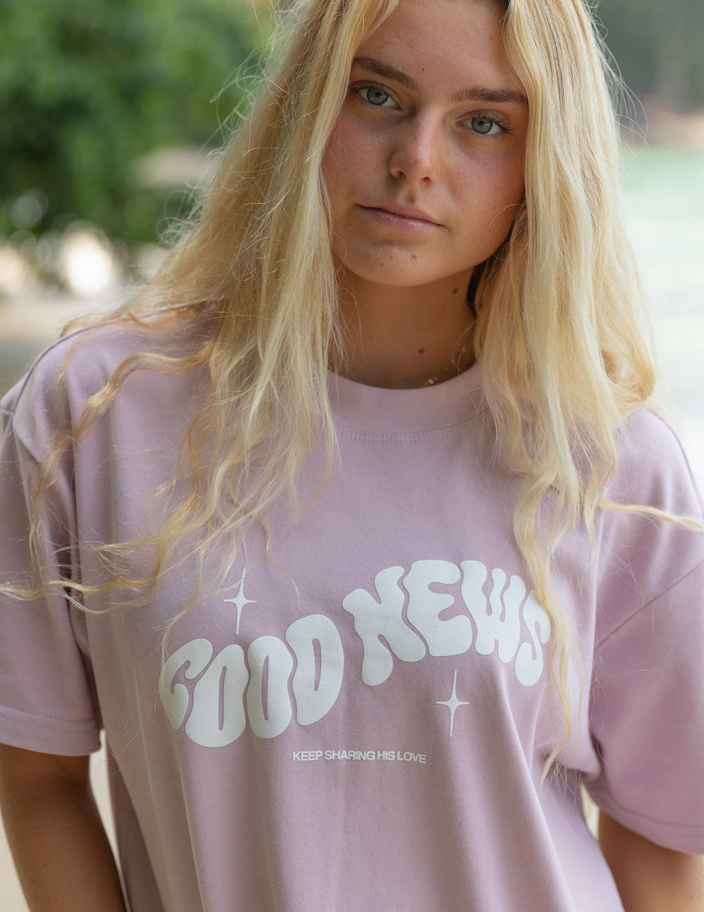 Elevated Faith Christian Apparel T-Shirt in light pink with 'Good News' graphic design