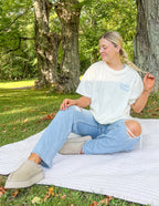 Model wearing Elevated Faith Christian Apparel T-Shirt in a serene outdoor setting