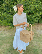 Elevated Faith Christian Apparel T-Shirt in soft gray paired with a white skirt and woven basket