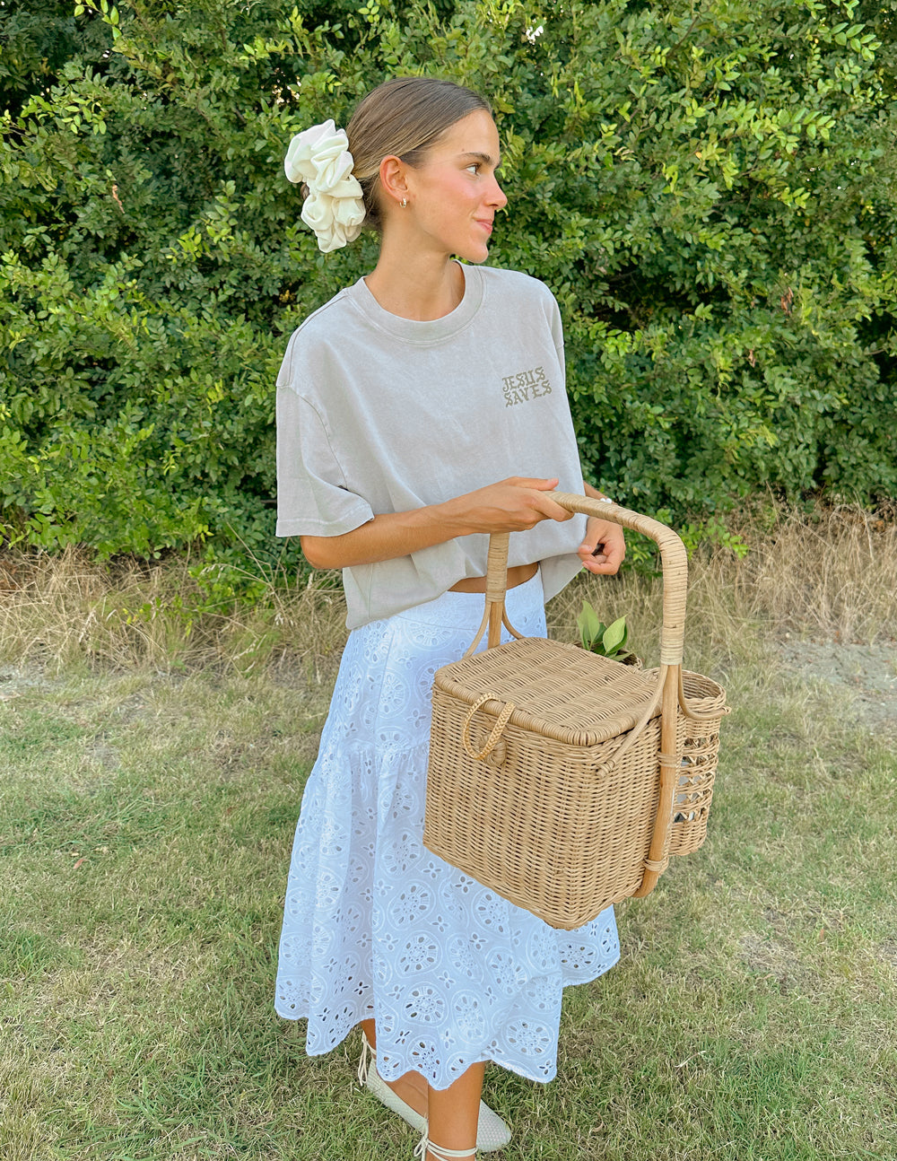 Elevated Faith Christian Apparel T-Shirt in soft gray paired with a white skirt and woven basket