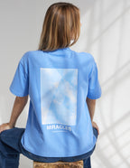 Light blue Elevated Faith Christian Apparel T-Shirt featuring a cloud graphic with the word Miracles