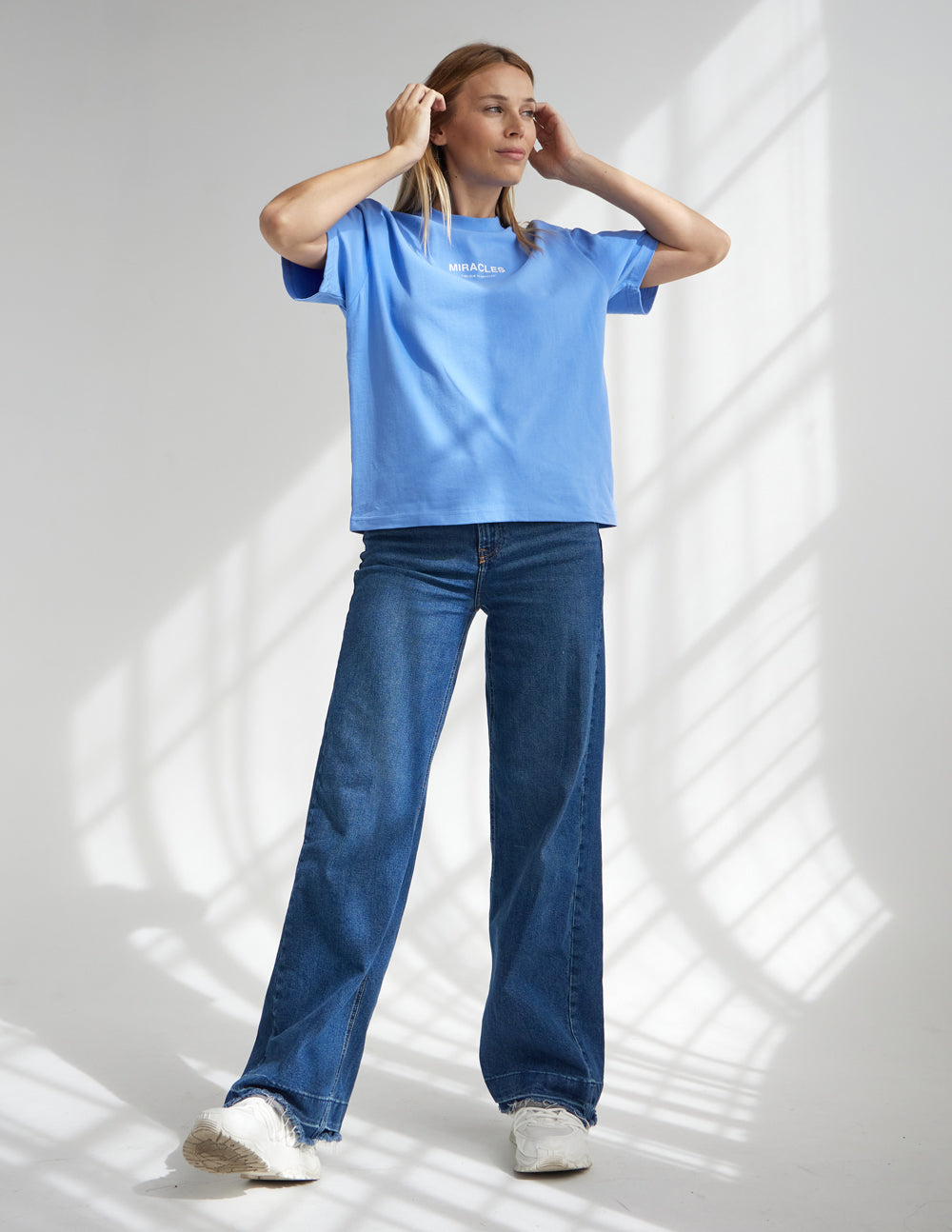 Elevated Faith Christian Apparel T-Shirt in blue, styled with wide-leg jeans for a trendy look