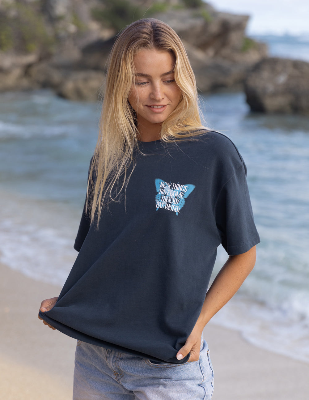 Elevated Faith Christian Apparel T-Shirt featuring a butterfly design on a beach backdrop