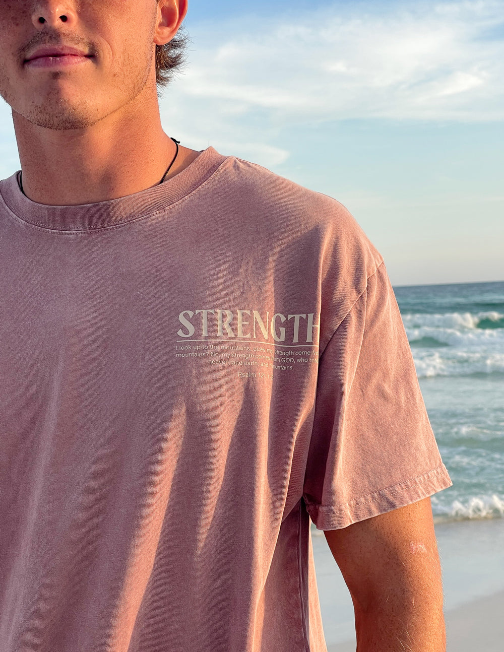 Elevated Faith Christian Apparel T-Shirt with 'Strength' graphic for inspirational wear at the beach