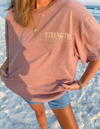 Elevated Faith Christian Apparel T-Shirt in soft pink with 'Strength' graphic on the front, perfect for casual wear