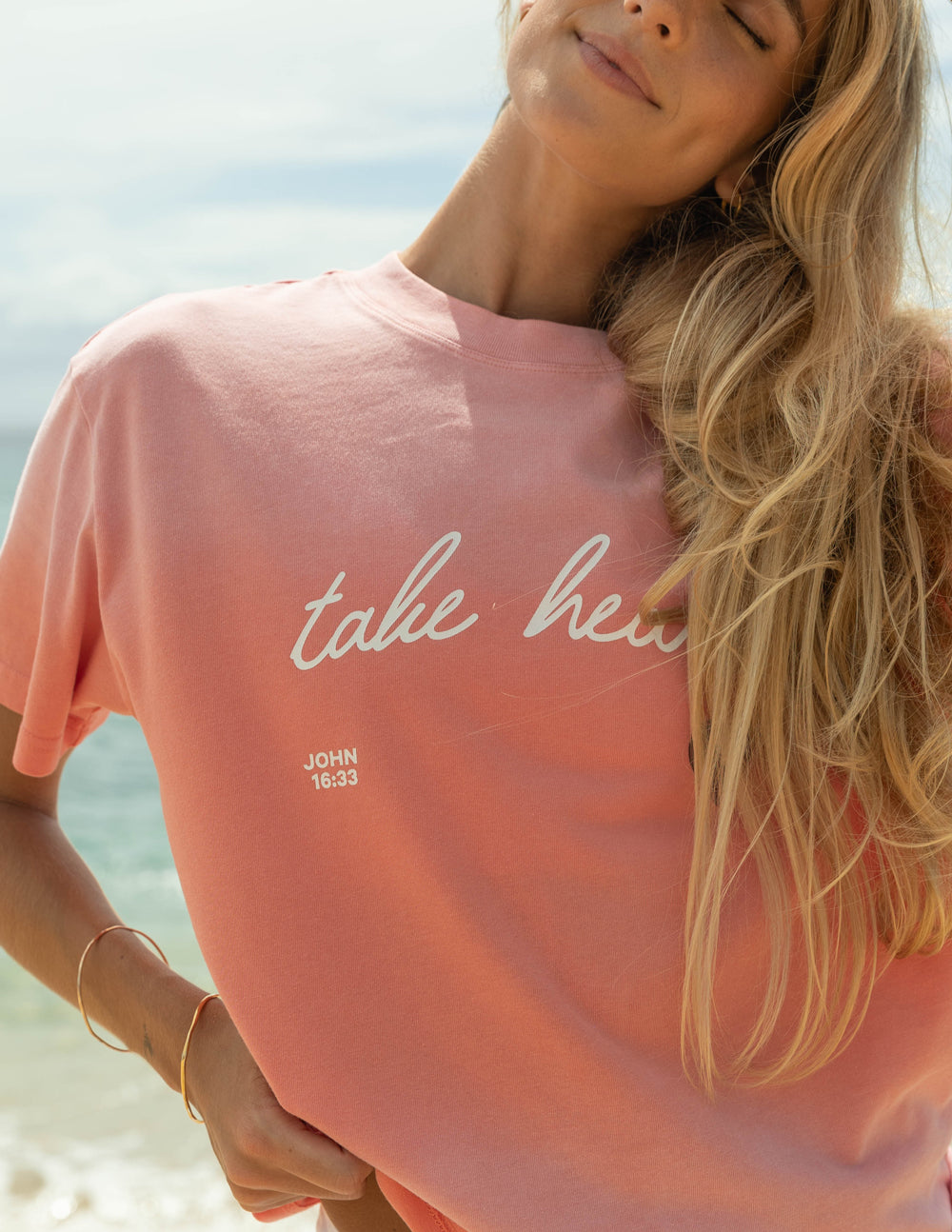 Elevated Faith Christian Apparel T-Shirt in Pink with 'take heart' design and John 16:33 verse