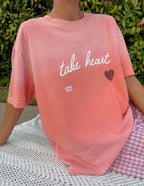 Elevated Faith Christian Apparel T-Shirt in pink with the message take heart and a heart graphic