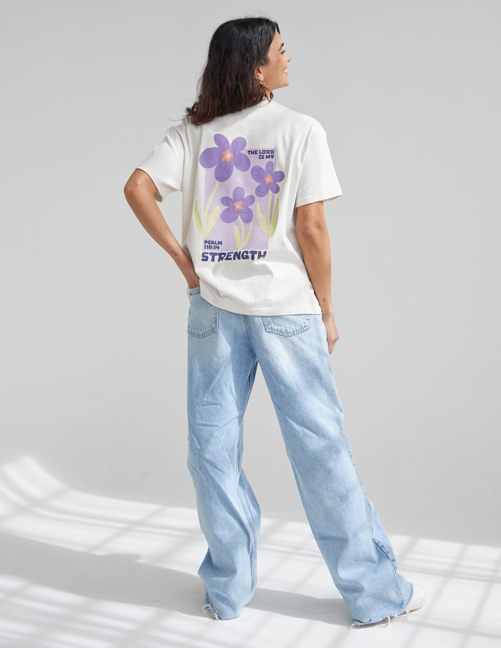 Elevated Faith Christian Apparel T-Shirt featuring a floral design with the word Strength