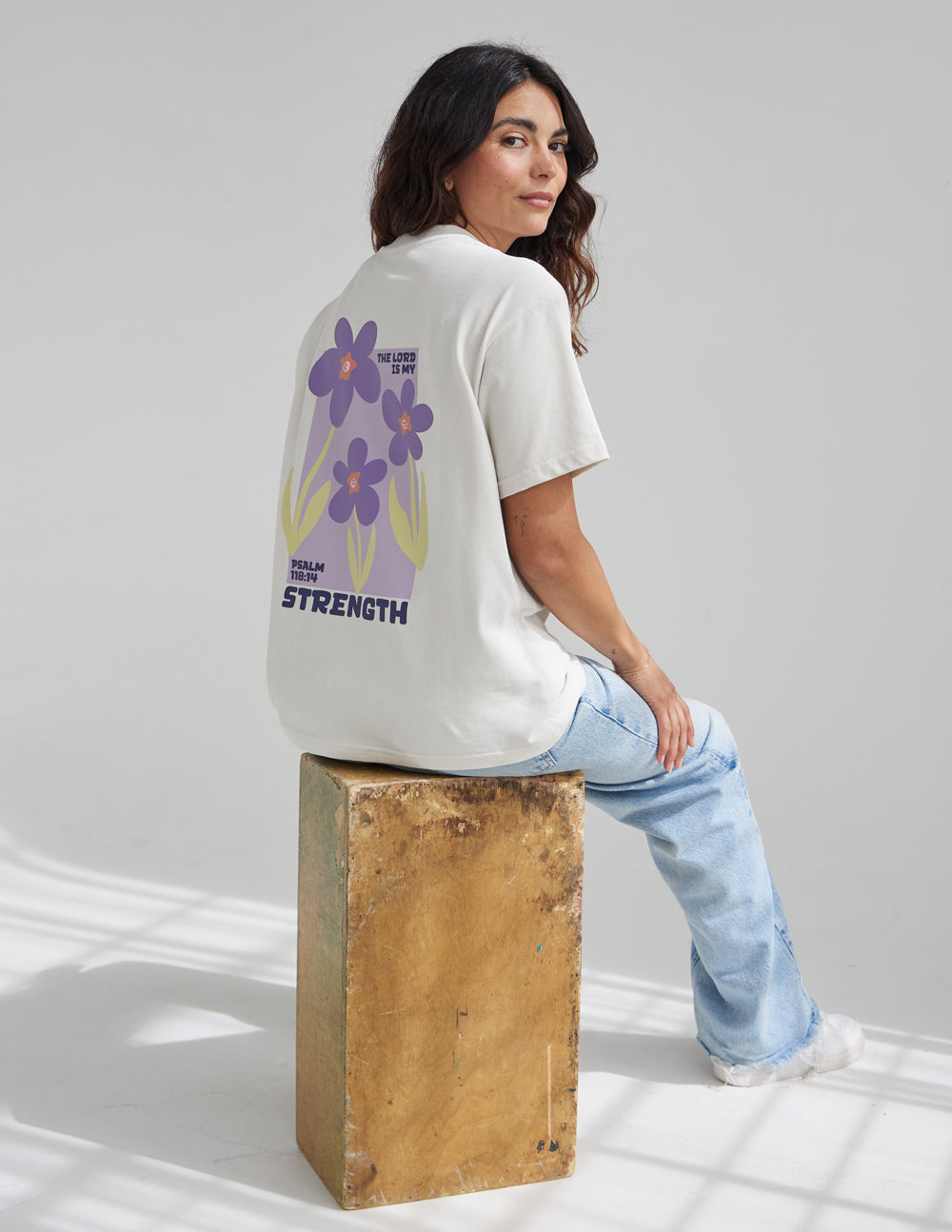 Elevated Faith Christian Apparel T-Shirt with Floral Design and 'True Strength' Text on Back