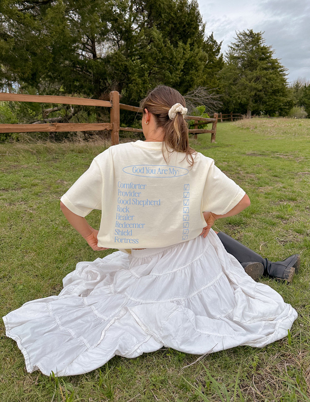 Elevated Faith Christian Apparel T-Shirt with inspirational design in a serene outdoor setting