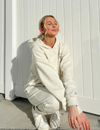 Model wearing a cozy cream Christian Hoodie from Elevated Faith, styled for casual comfort