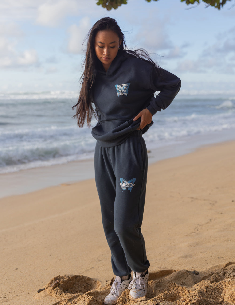 Elevated Faith Christian Hoodie in dark blue modeled on a beach for a casual look