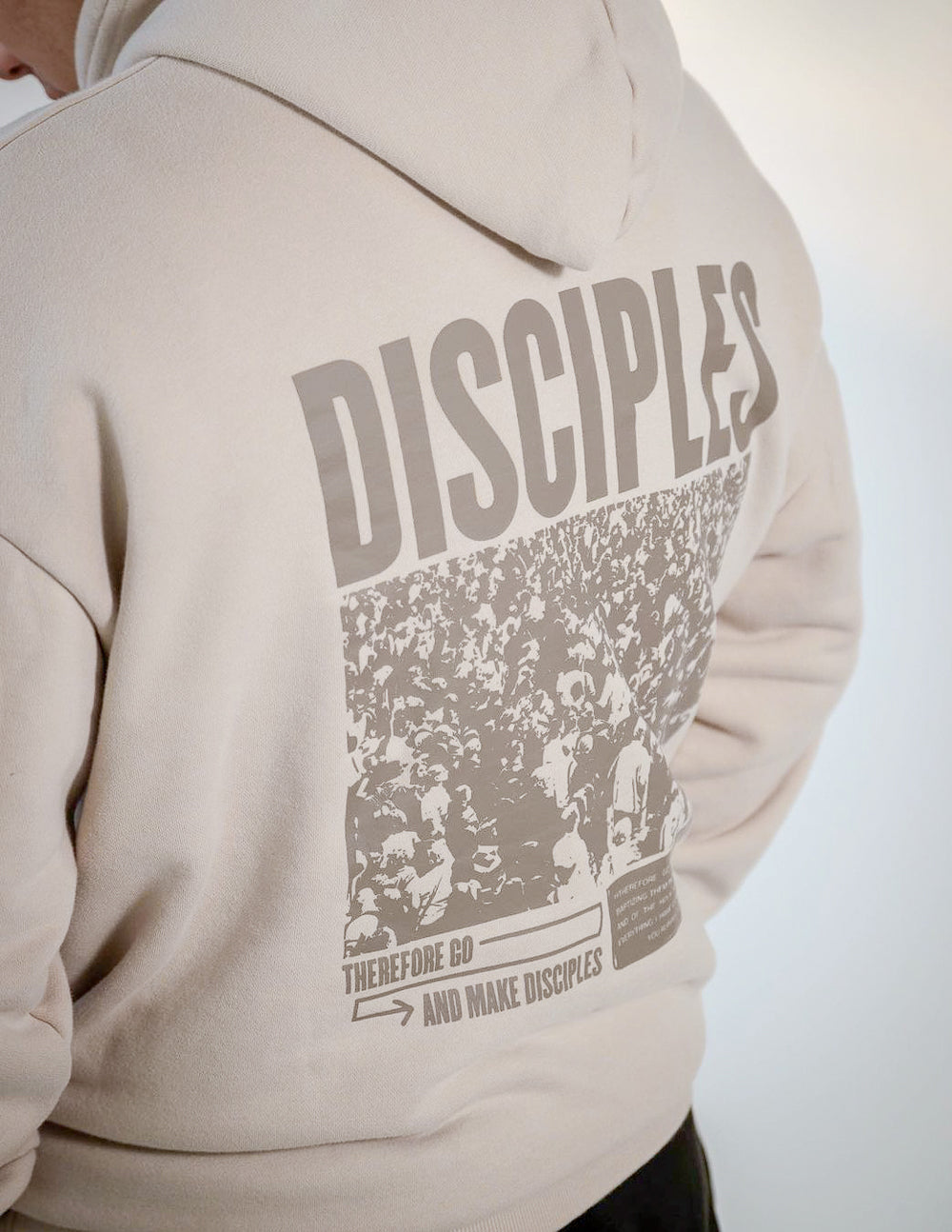 Elevated Faith Christian Hoodie in beige with a large 'DISCIPLES' graphic on the back