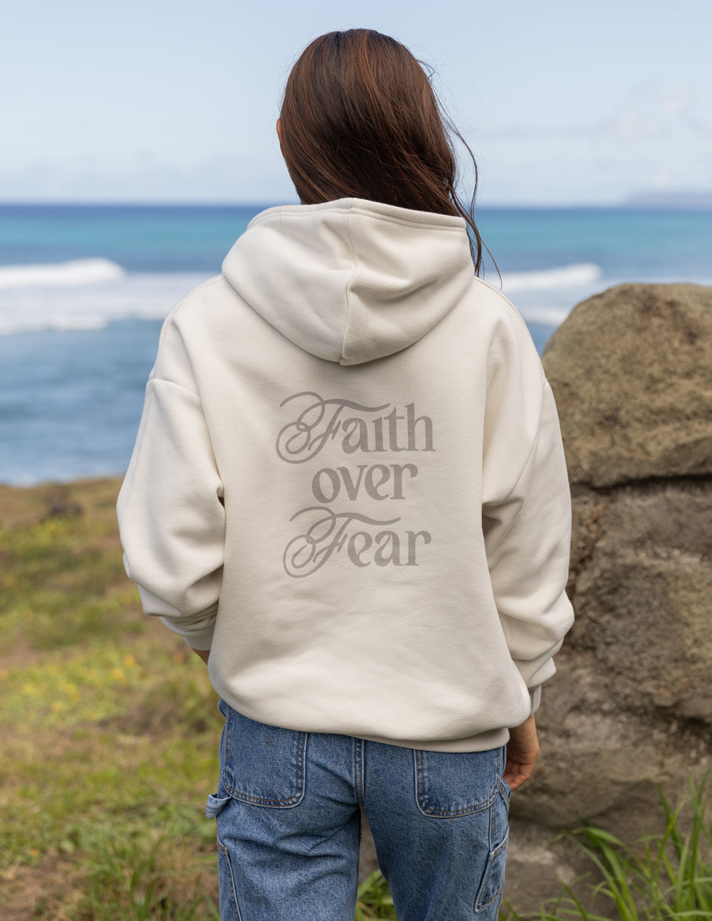 Elevated Faith Christian Hoodie in light color featuring Faith over Fear text on the back