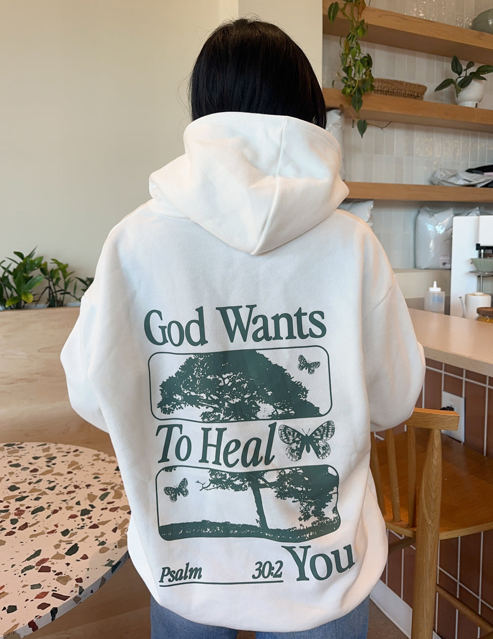 Elevated Faith Christian Hoodie featuring uplifting message 'God Wants To Heal You' and nature-inspired design