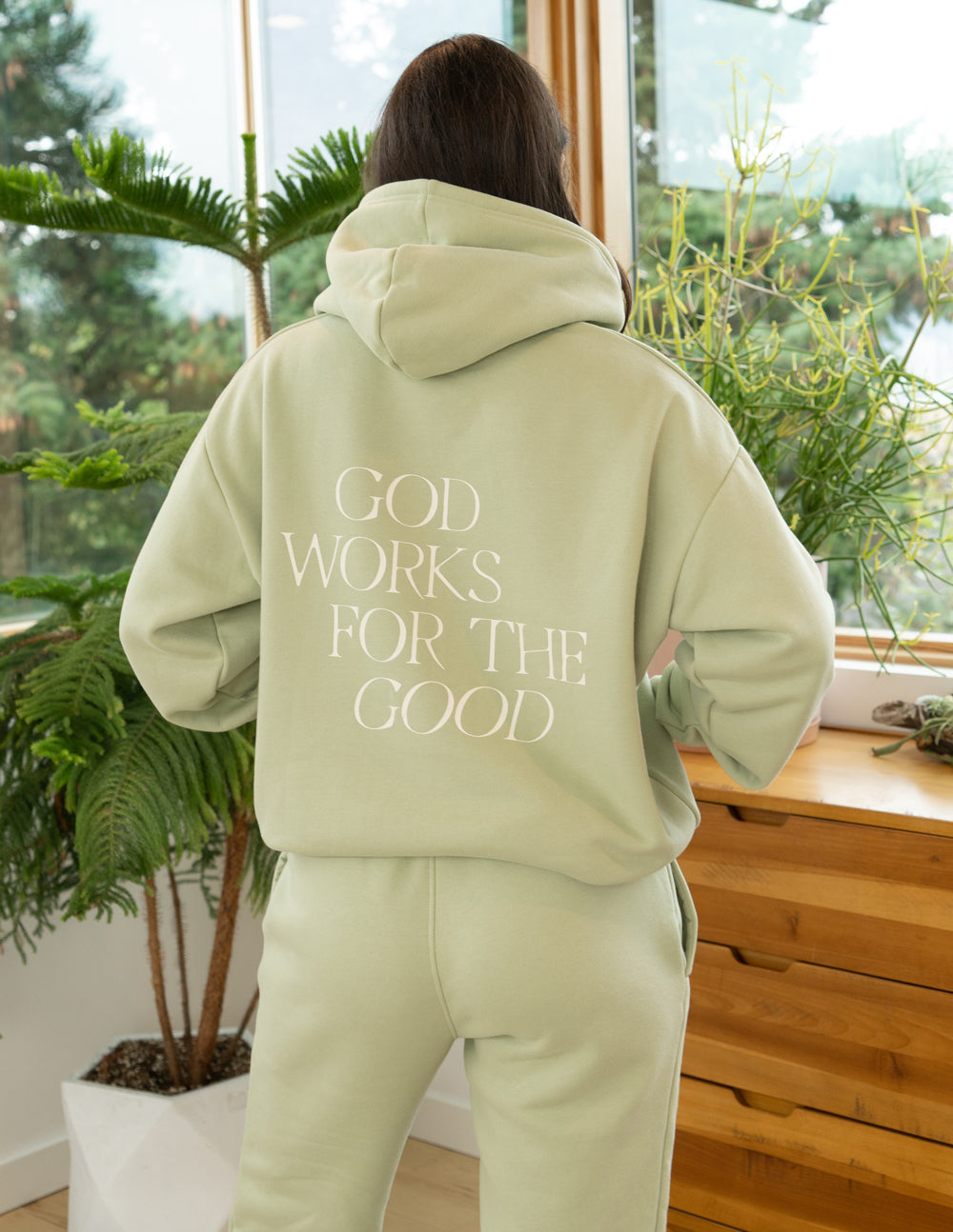 Elevated Faith Christian Hoodie in light green with 'God Works for the Good' text on the back