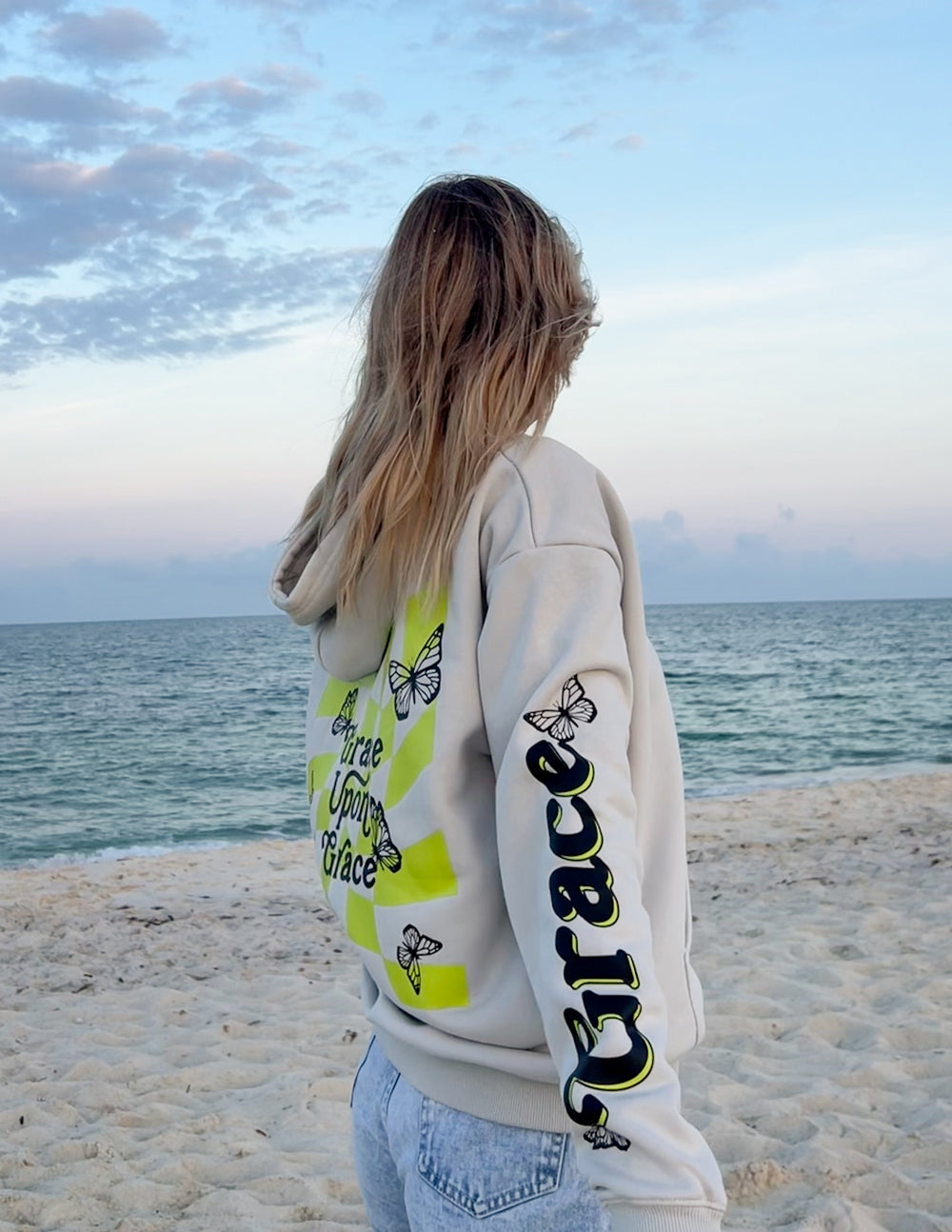 Elevated Faith Christian Hoodie in Light Gray with Butterfly Graphics on the Beach