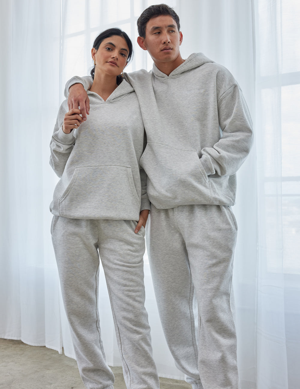 Cozy gray Christian Hoodie from Elevated Faith worn by a couple in casual attire