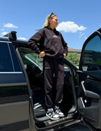 Elevated Faith Christian Hoodie in Black, styled with matching pants for a casual look