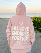 Pink Christian Hoodie from Elevated Faith featuring 'His Love Endures Forever' graphic on the back