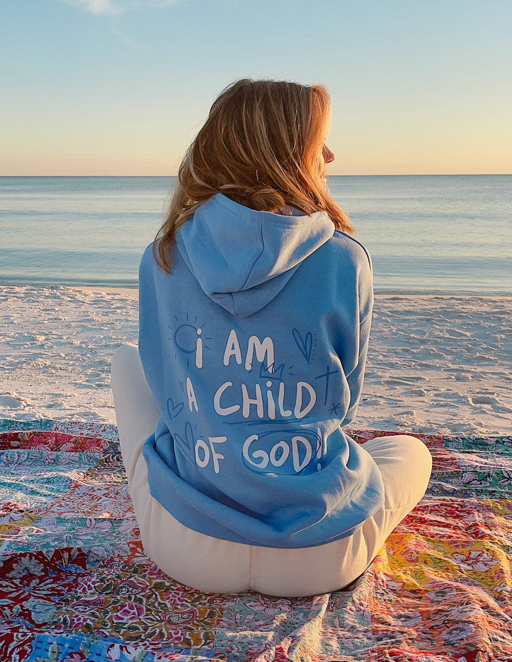 Light blue Christian Hoodie featuring the phrase I Am A Child of God on the back, perfect for beach outings