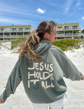 Elevated Faith Christian Hoodie in Green with 'Jesus Holds It All' Design for Comfortable Casual Wear