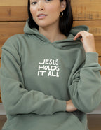 Elevated Faith Christian Hoodie in Olive Green with 'Jesus Holds It All' Print on Front