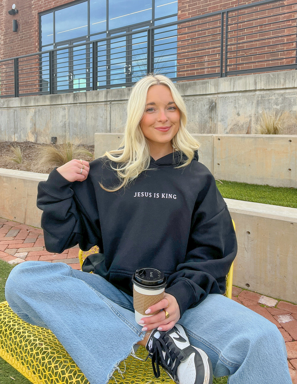 Black Christian Hoodie from Elevated Faith featuring 'Jesus Is King' text for casual comfort