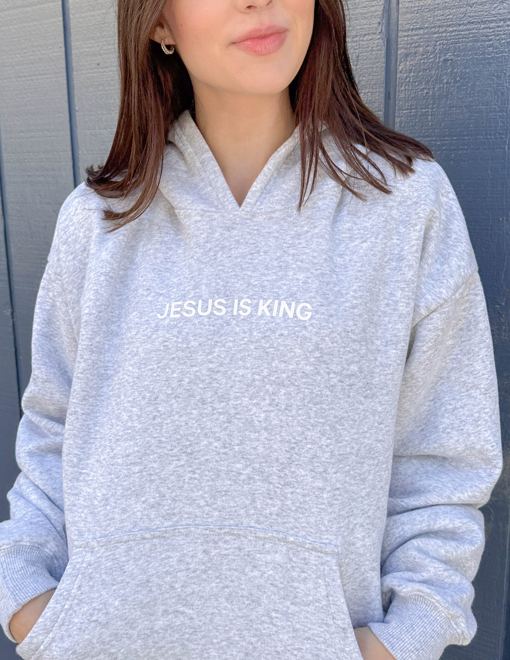 Elevated Faith Christian Hoodie in gray with 'JESUS IS KING' text on the front