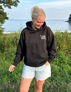 Black Elevated Faith Christian Hoodie for casual wear by the outdoor water view