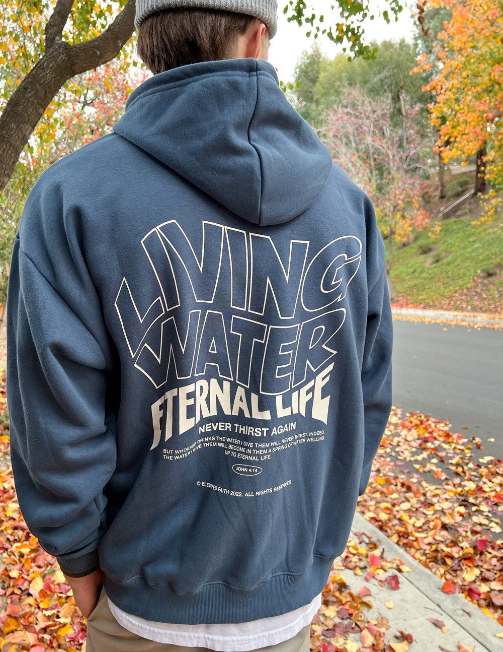 Elevated Faith Christian Hoodie in navy featuring 'Living Water Eternal Life' graphic on the back