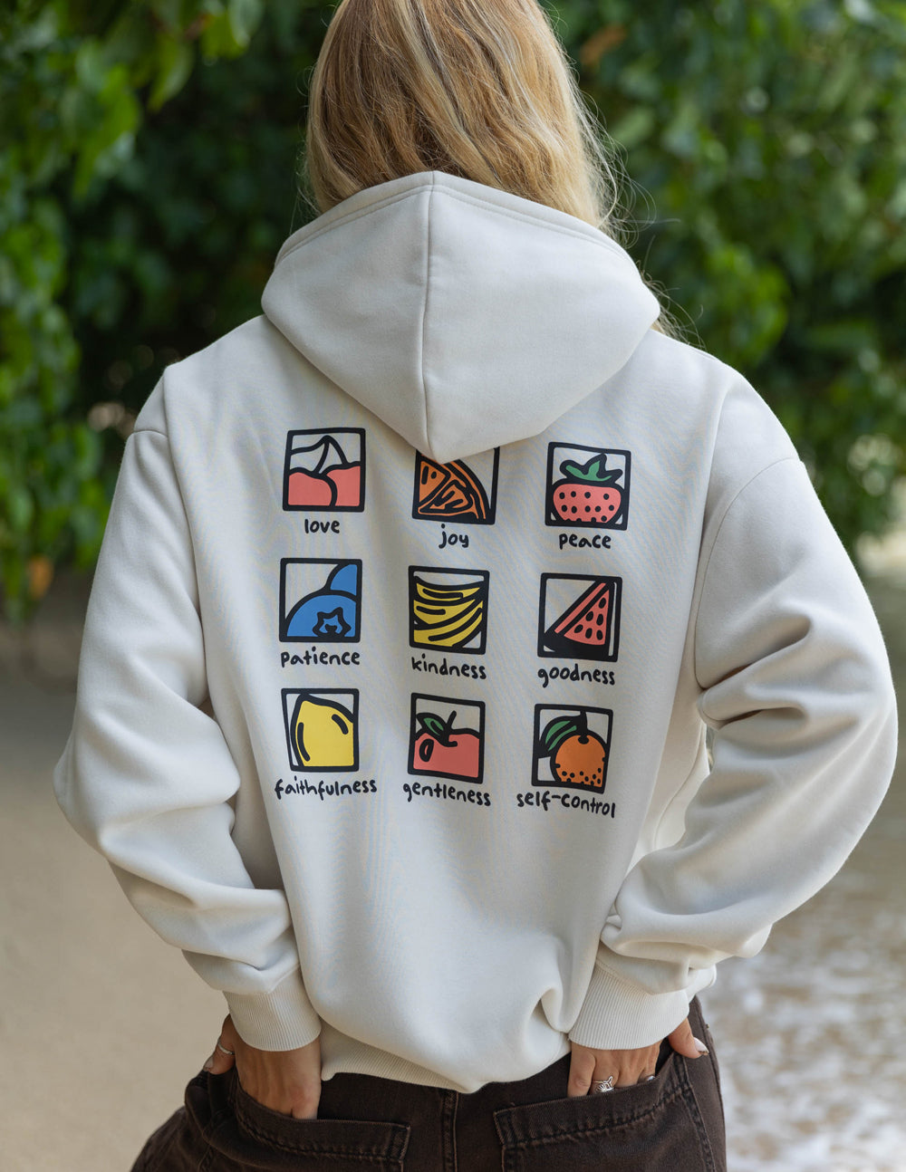 Elevated Faith Christian Hoodie featuring colorful icons of love, joy, peace, and other virtues on the back