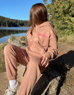 Elevated Faith Christian Hoodie in soft pink, perfect for outdoor relaxation by the lake